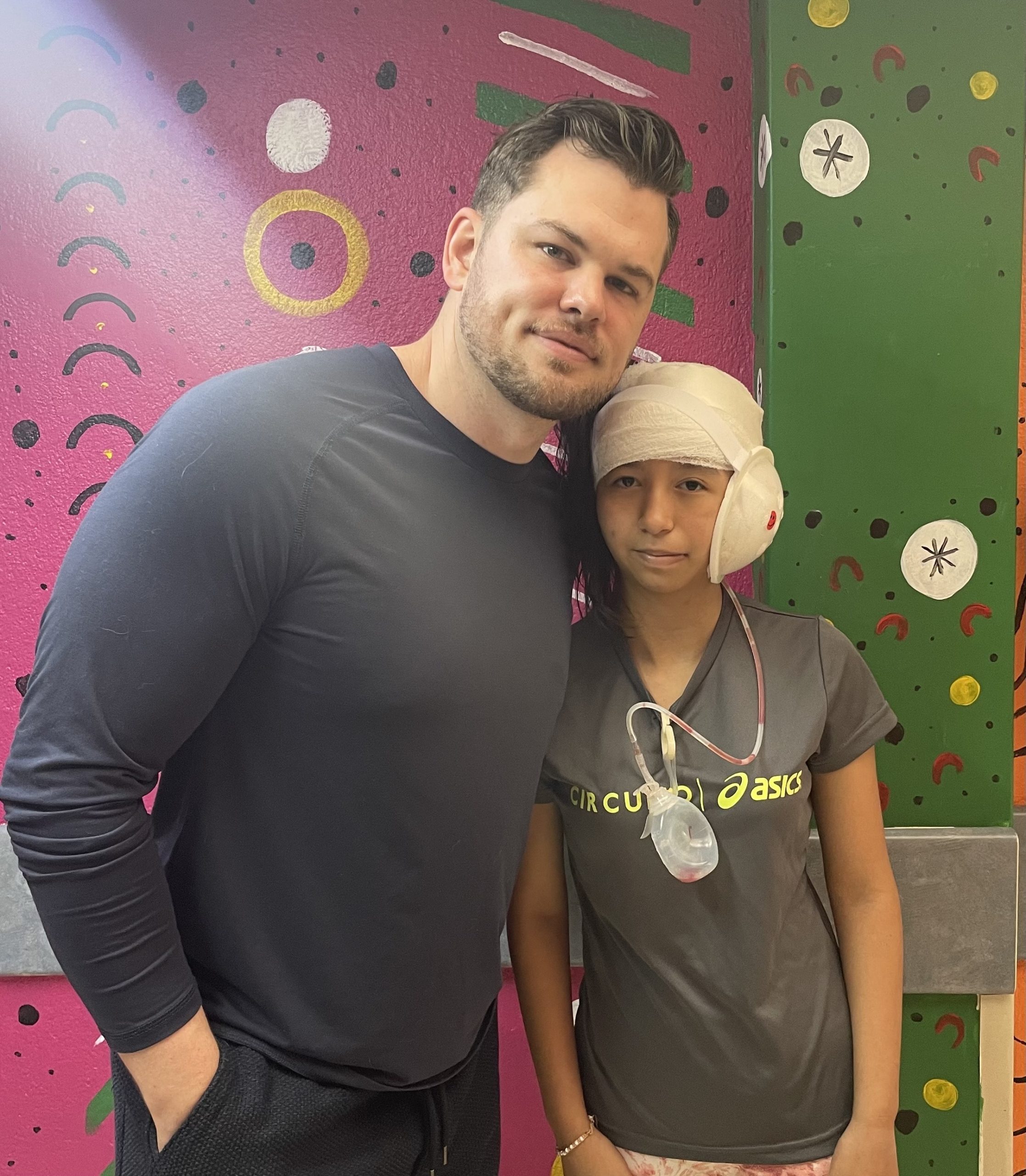 Dr. Tyler Okland with a pediatric reconstructive surgery patient